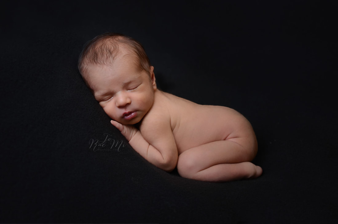 14 day old bare baby boy on black {ontario newborn photographer}