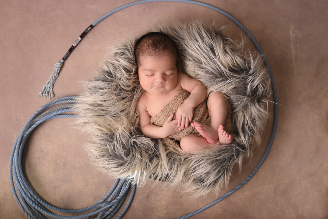 eight day old baby boy with western rope 