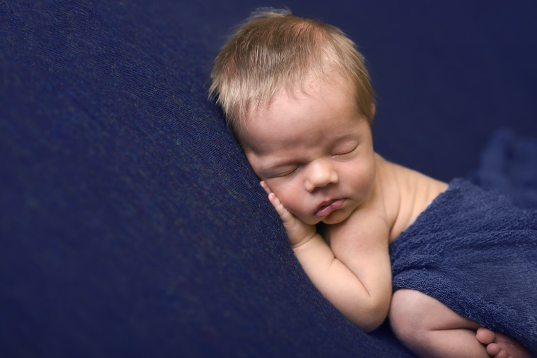 newborn baby boy on blue blanket
